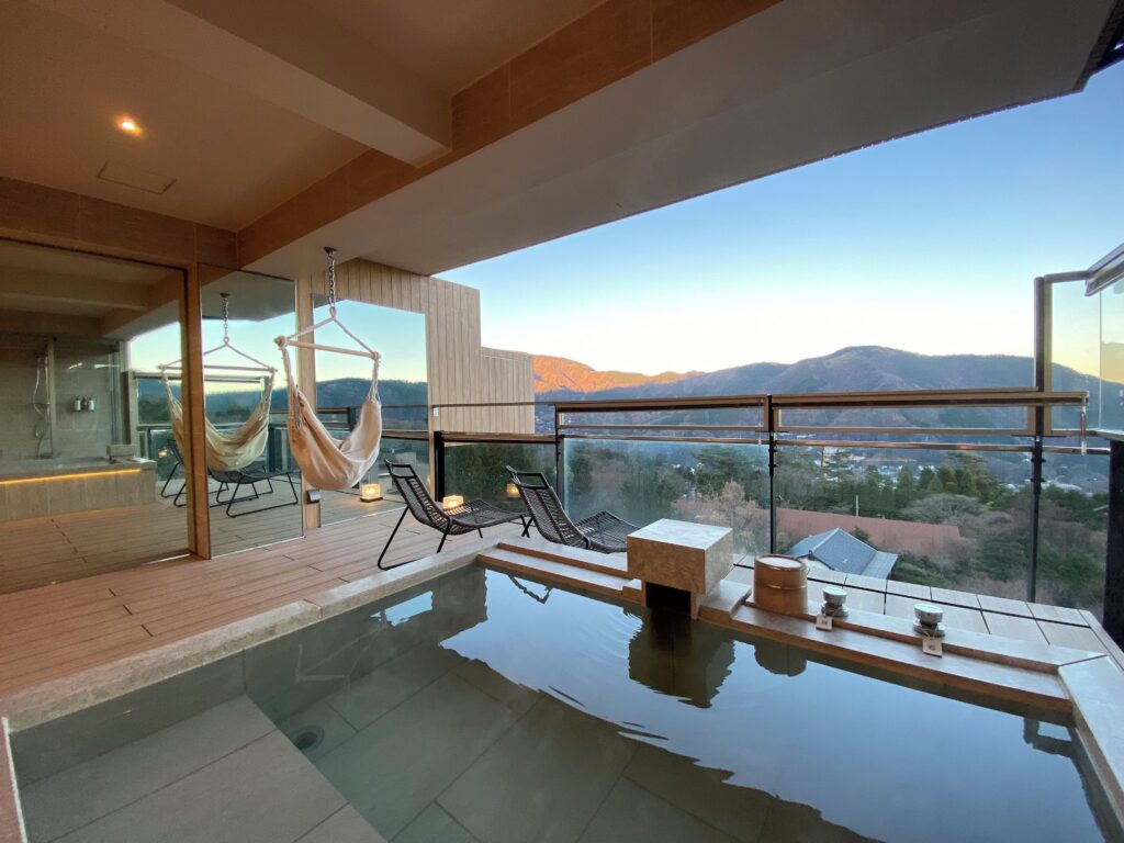 Private terrace with outdoor onsen bath and mountain views at Gen Hakone