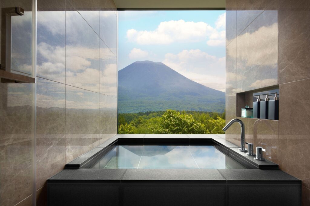 A deep soaking tub framing Mount Yotei at Higashiyama Niseko Village