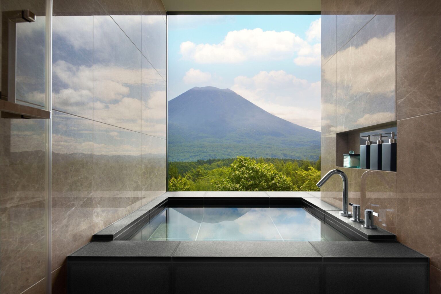 A deep soaking tub framing Mount Yotei at Higashiyama Niseko Village