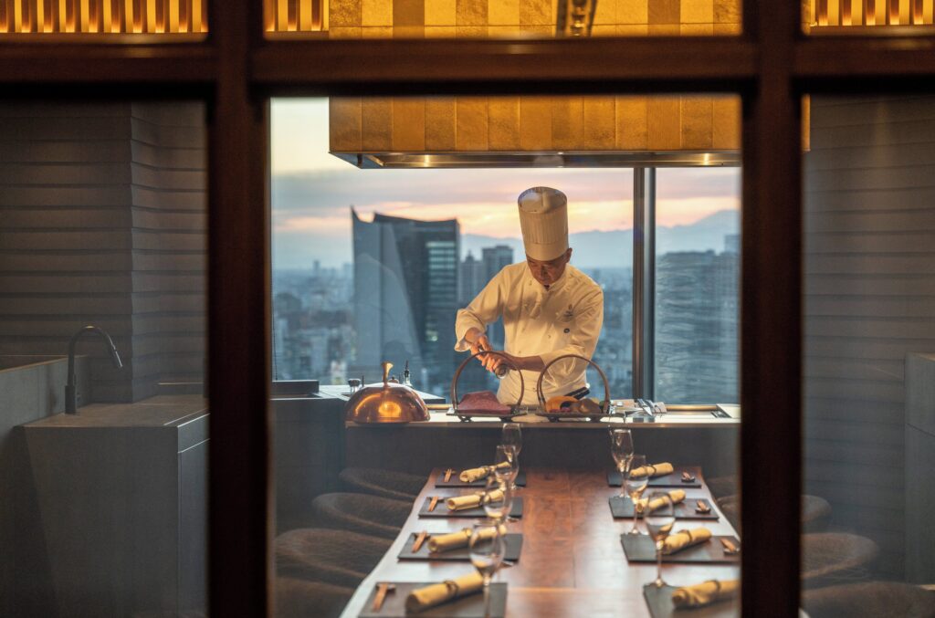 Chef at the Teppanyaki Akasaka counter above the Tokyo skyline