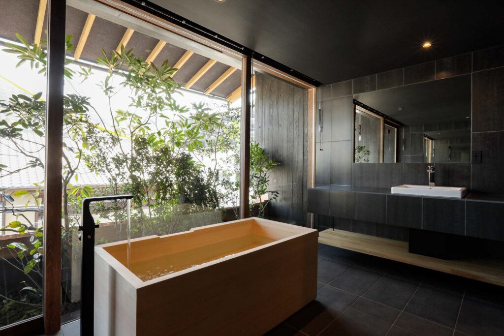 Cypress bath facing greenery in a Sowaka guest room