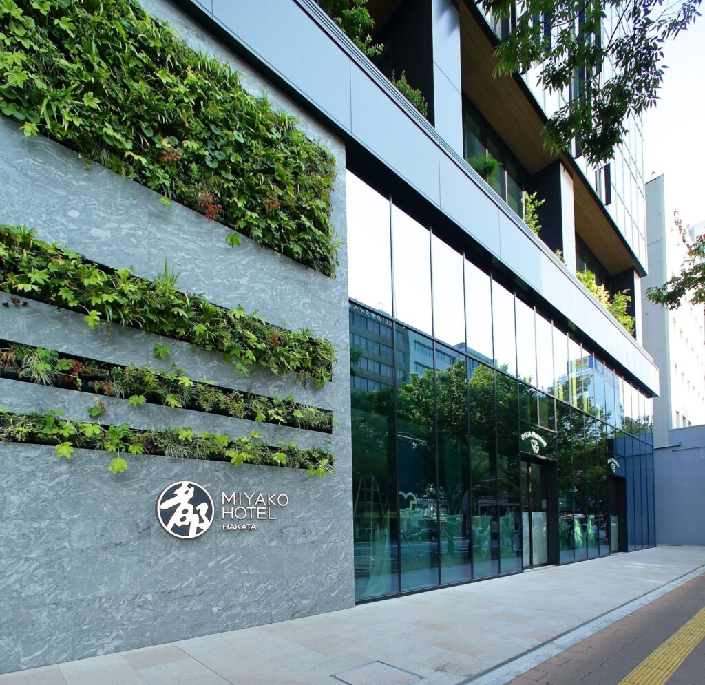 Exterior entrance of Miyako Hotel Hakata with a planted wall