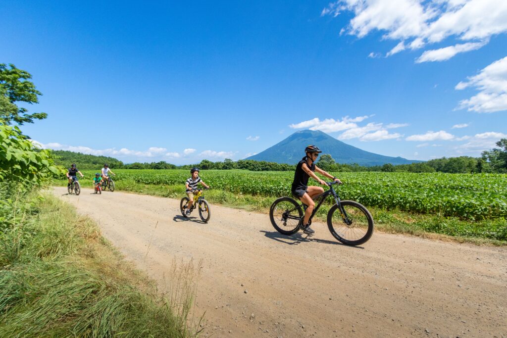 Family cycling near Mount Yotei during Niseko green season