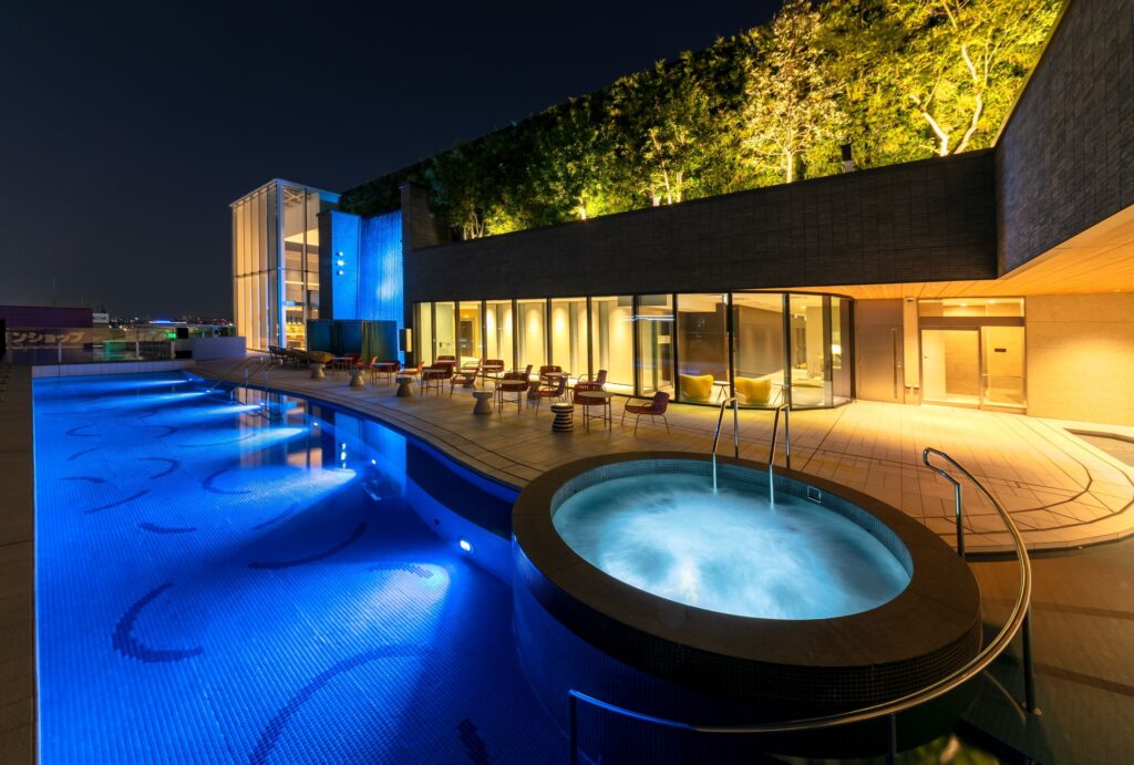 SPA lucida outdoor pool and circular jet bath illuminated at night