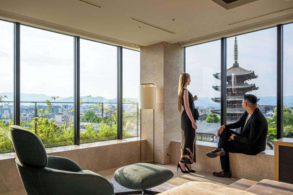 Guests looking through floor-to-ceiling windows towards Yasaka Pagoda at The Hotel Seiryu Kyoto Kiyomizu