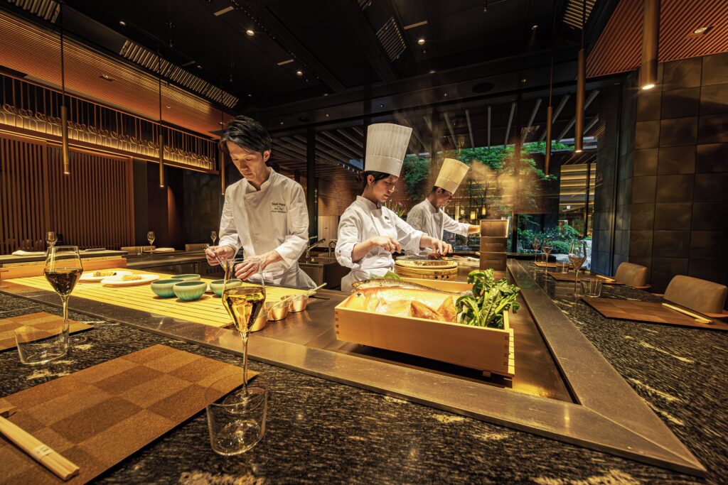Chefs preparing dishes at the counter in Dusit Thani Kyoto