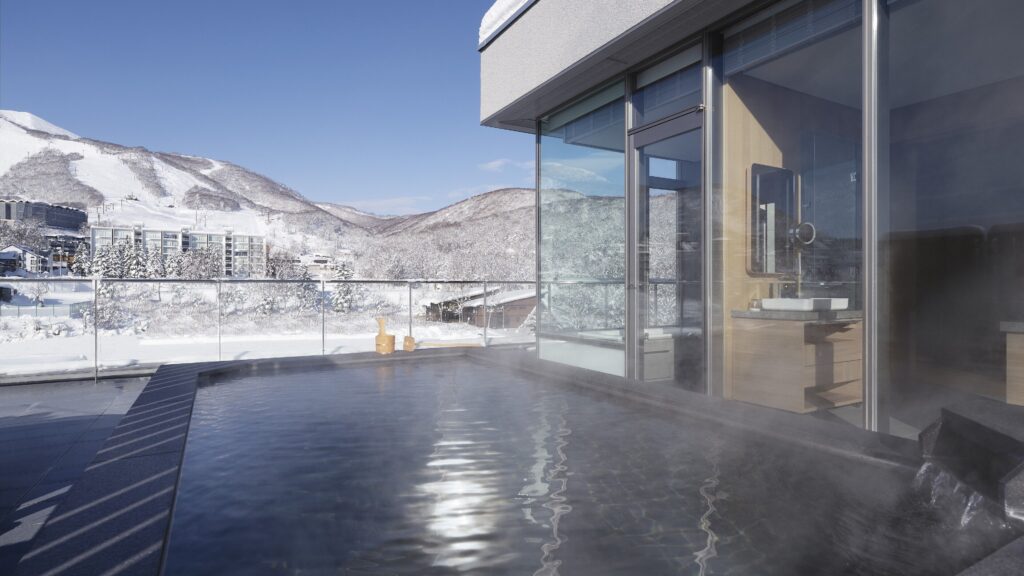 Outdoor onsen at Setsu Niseko overlooking snow-covered mountains