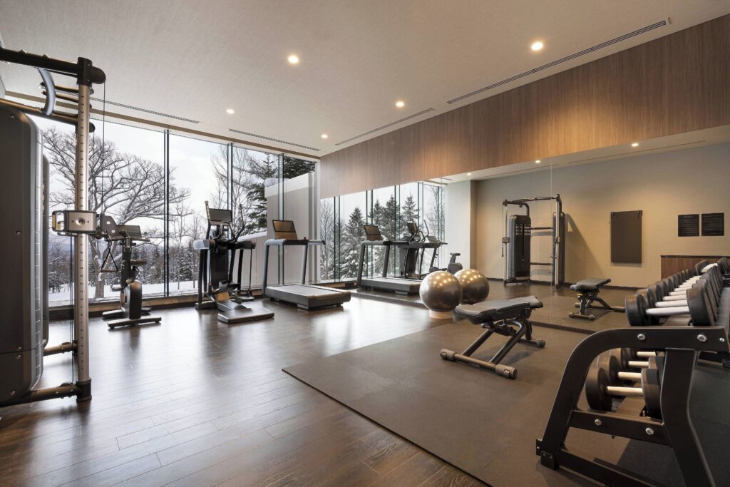 The fitness centre facing snow-covered trees at Higashiyama Niseko Village