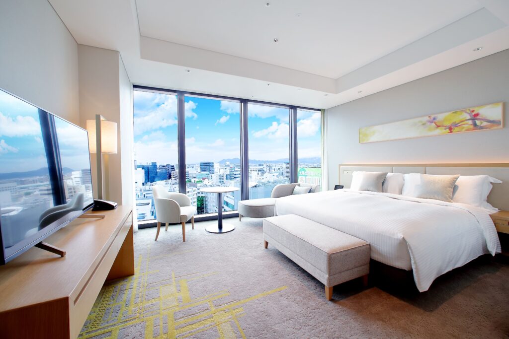 Guest room at Miyako Hotel Hakata with a large bed and floor-to-ceiling windows