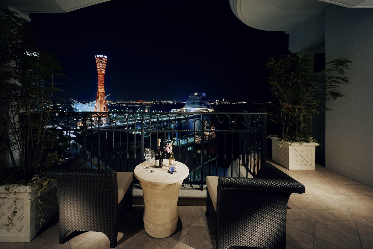 Furnished ocean-view terrace at Hotel La Suite Kobe Harborland at night