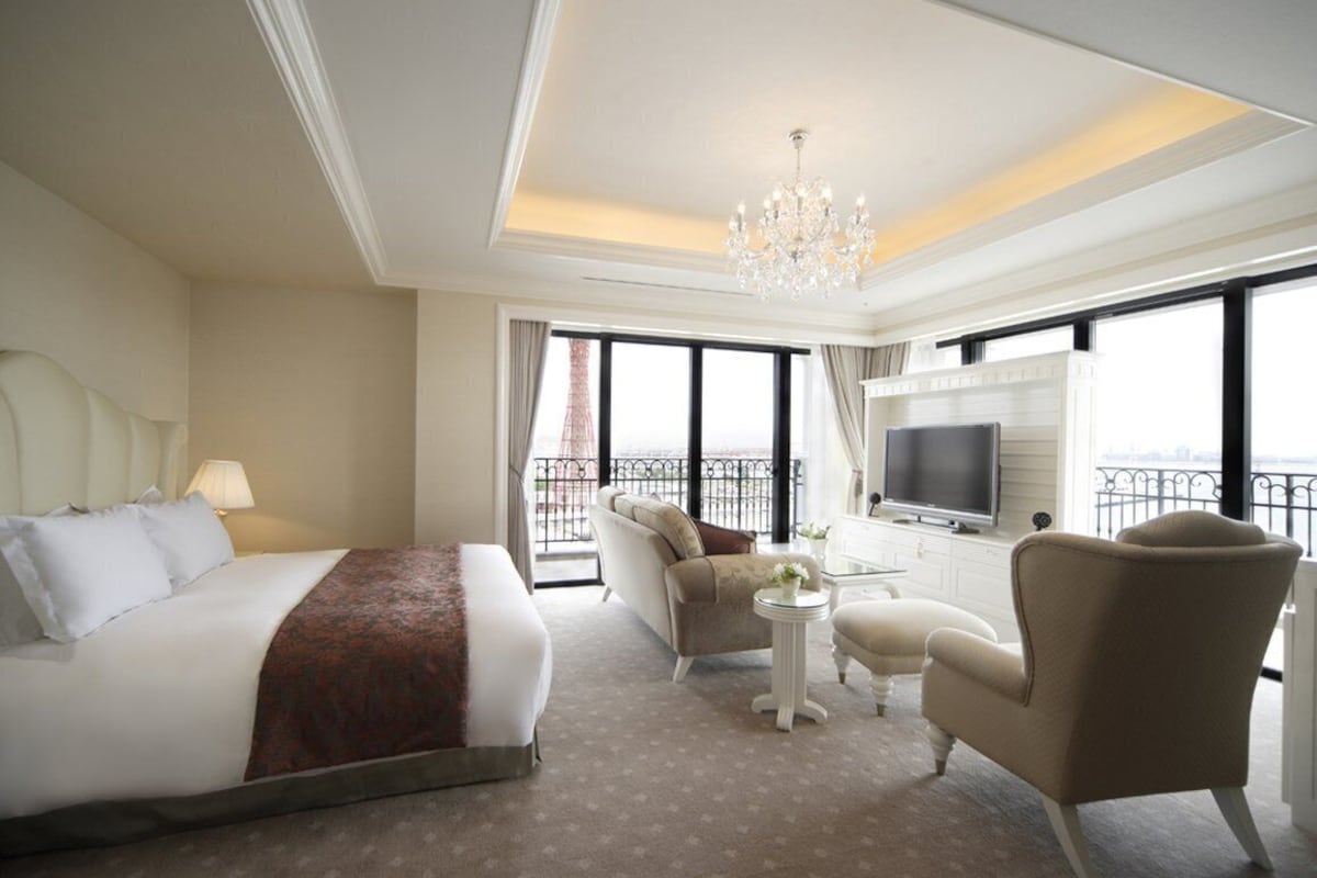 Spacious double room with seating area and balcony at Hotel La Suite Kobe Harborland