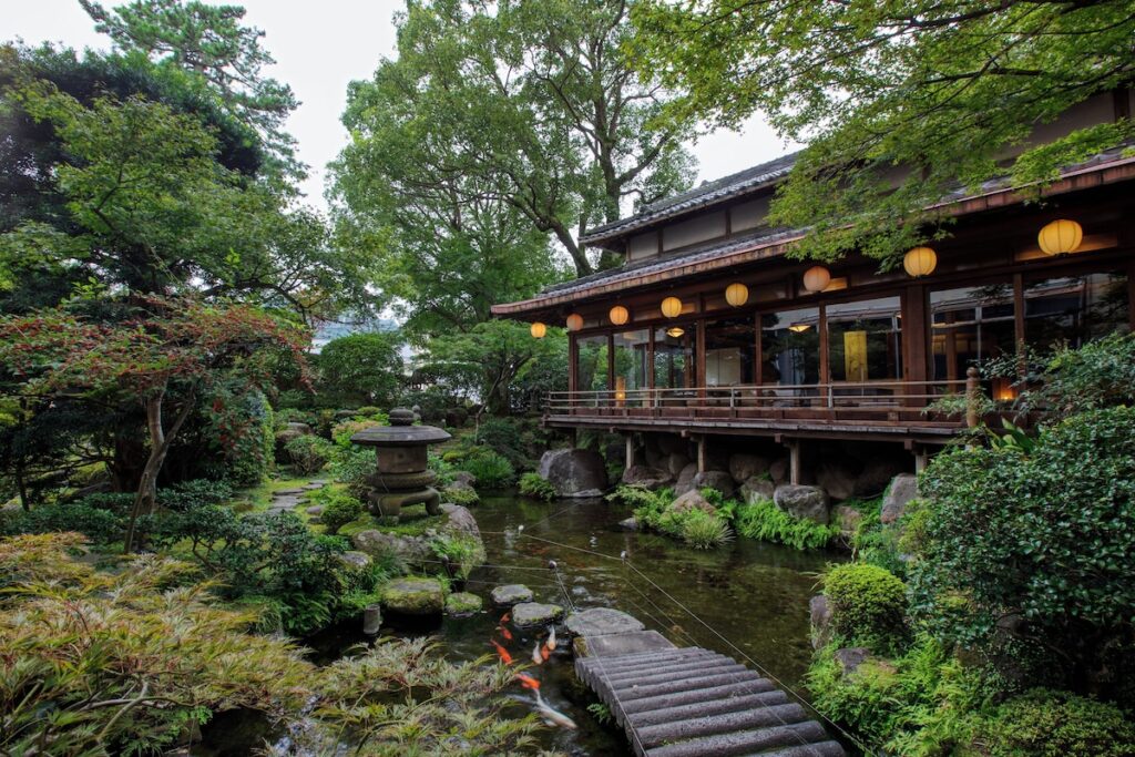 Hotel Shiragiku's Hyakunen Japanese garden with koi pond and wooden bridge