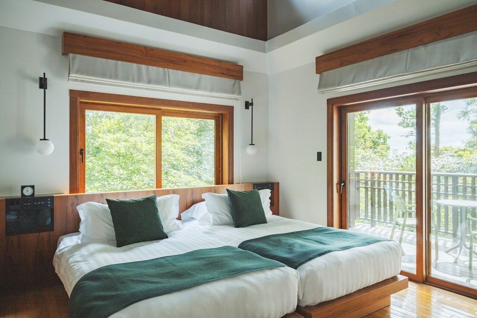 Twin bedroom and balcony in a Manasa Villa at sankara hotel and spa Yakushima