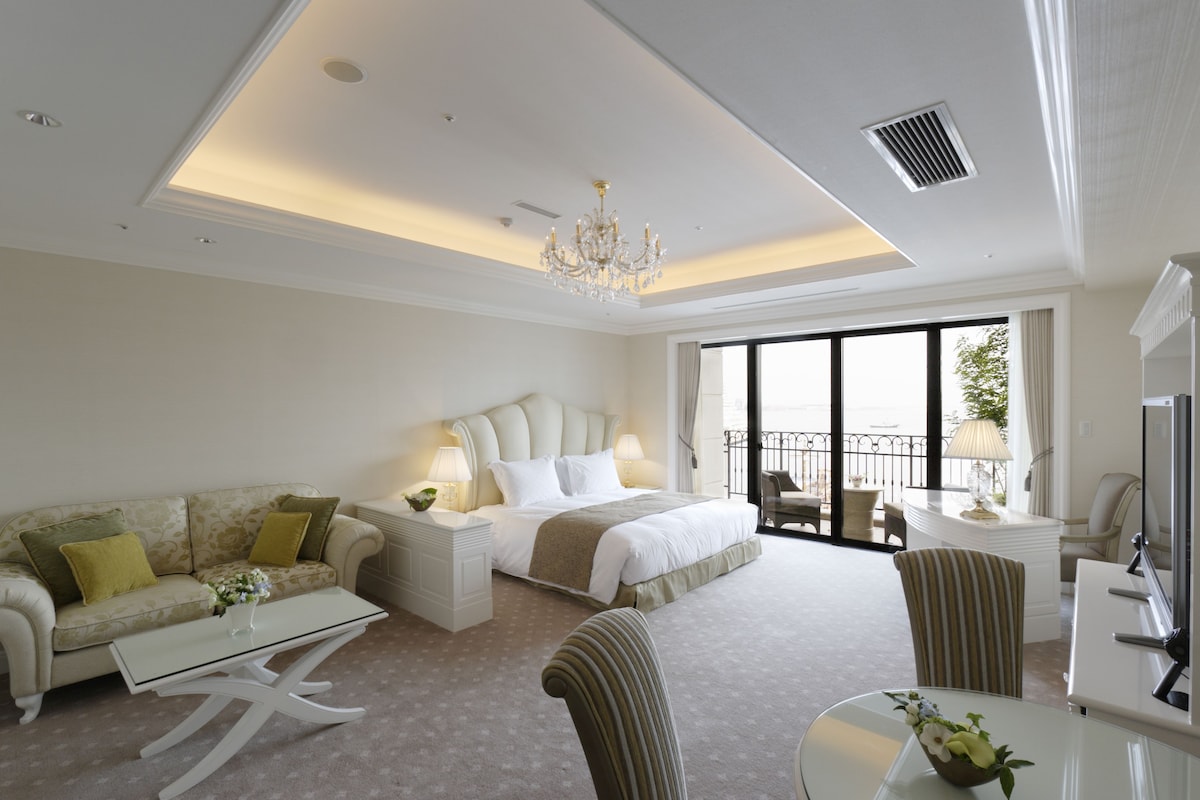 Guest room opening to an ocean-view balcony at Hotel La Suite Kobe Harborland