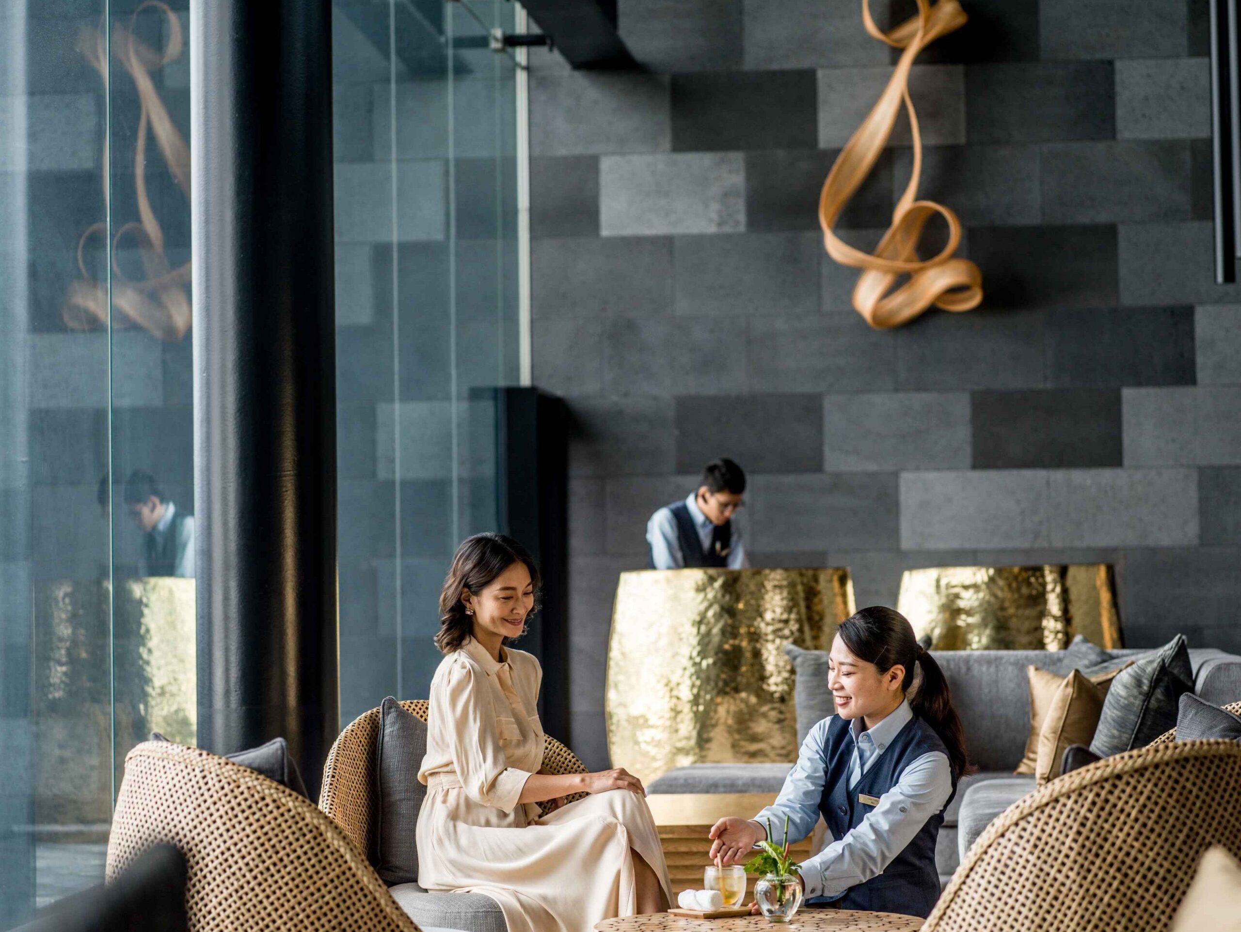 Light-filled lobby at ANA InterContinental Beppu with woven seating and panoramic windows