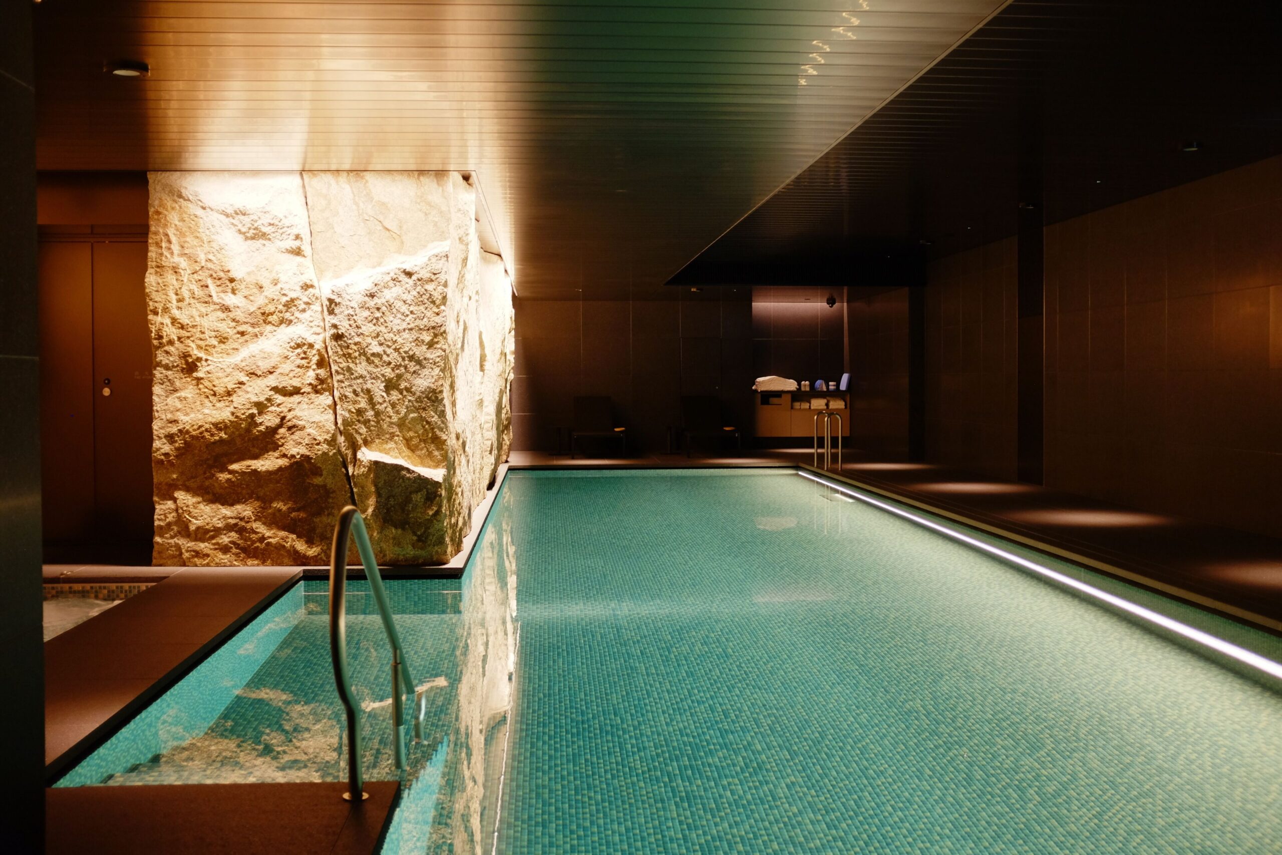 Indoor pool with illuminated stone wall at Imperial Hotel Kyoto