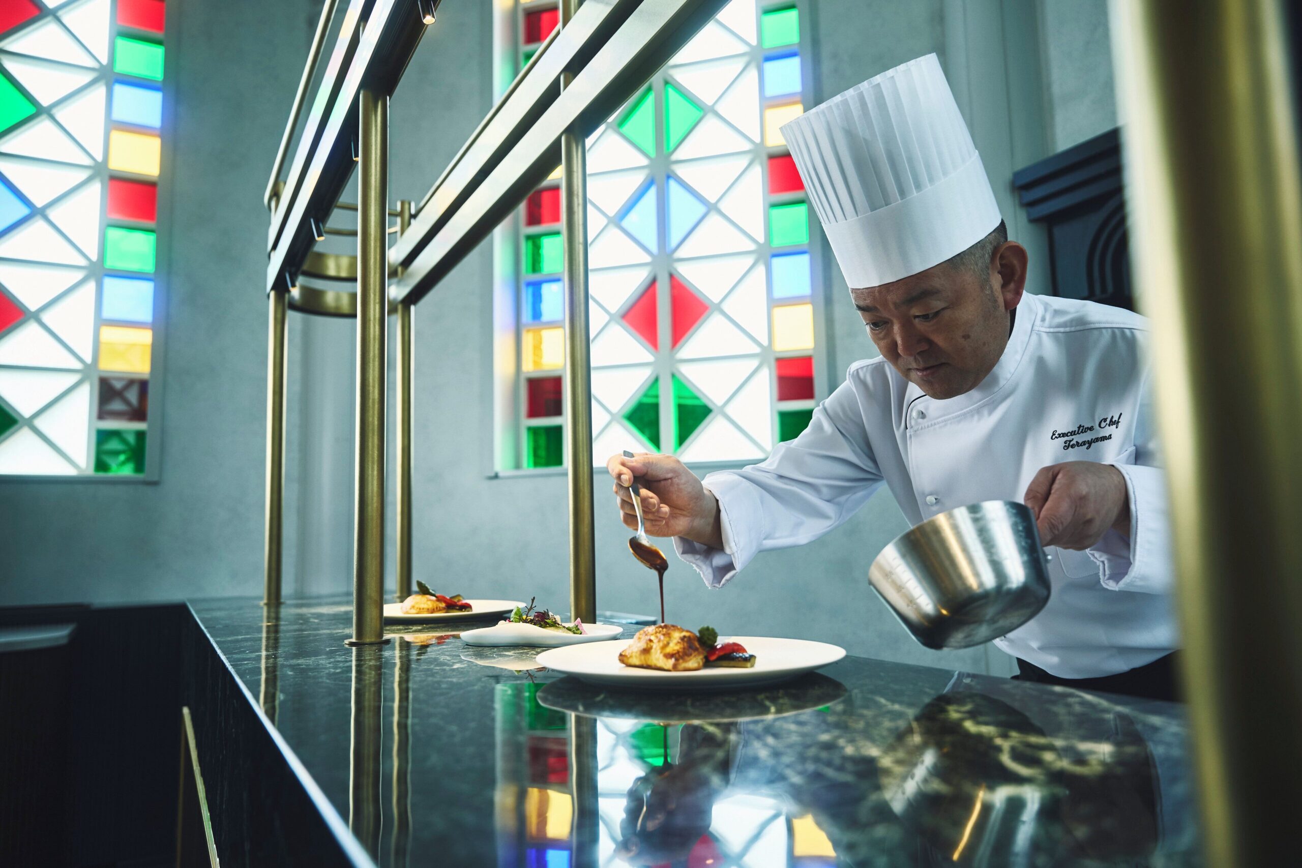 Chef preparing a dish at Hotel Indigo Nagasaki Glover Street
