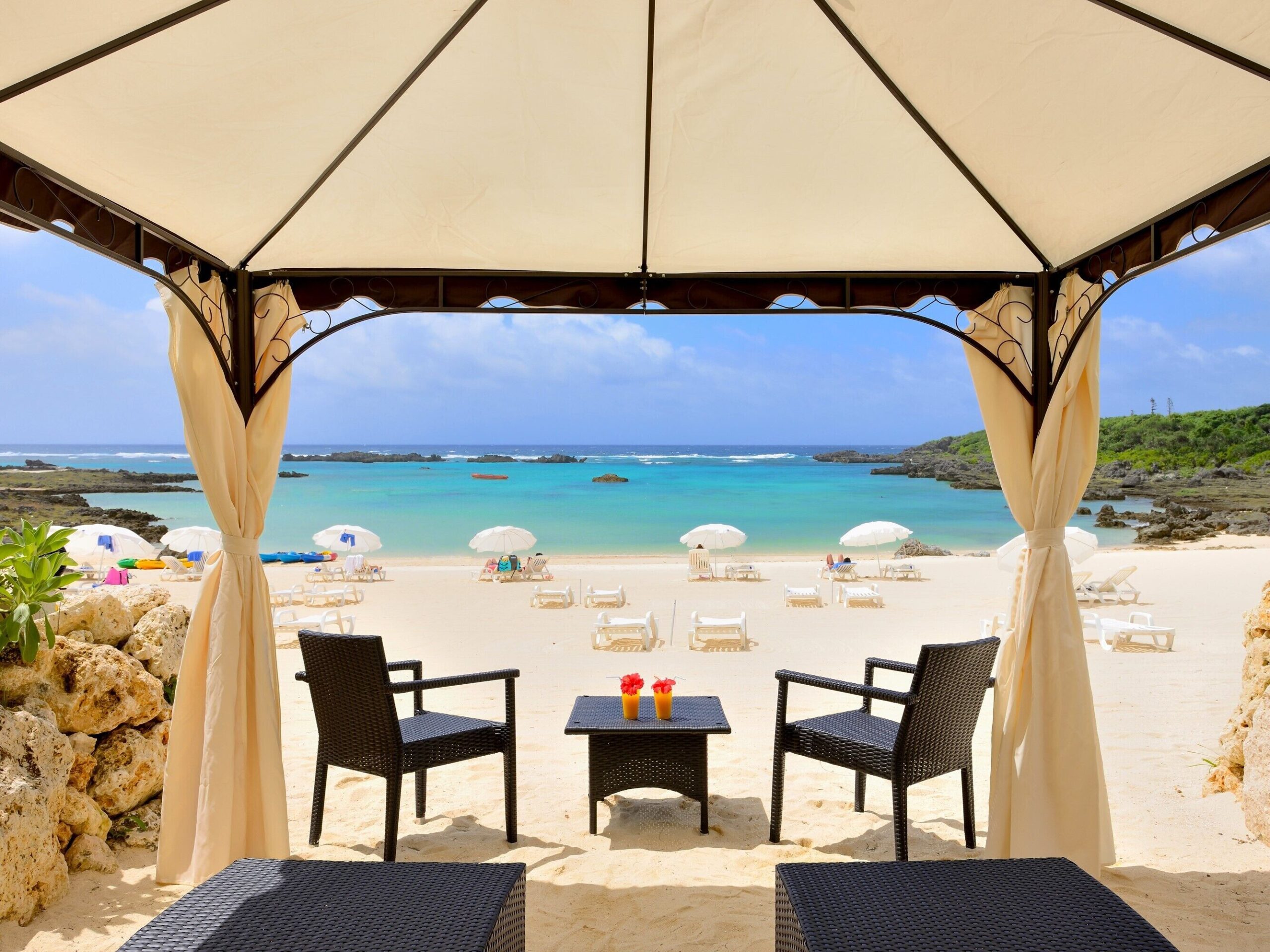 Shaded seating overlooking a beach