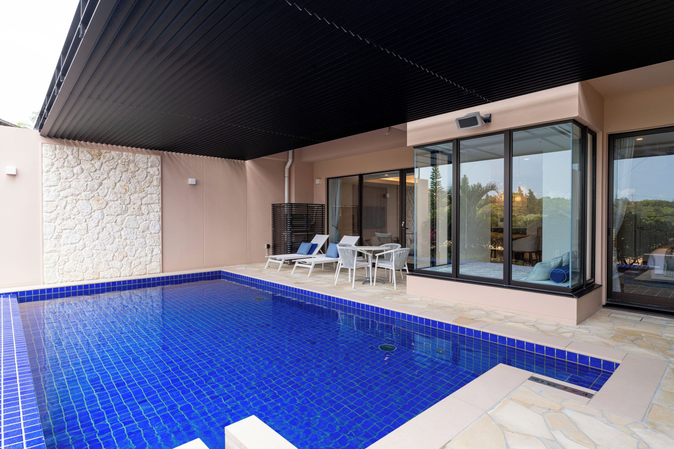 Blue-tiled private pool, loungers and covered terrace of a Garden Pool Suite at ALLAMANDA Splendid