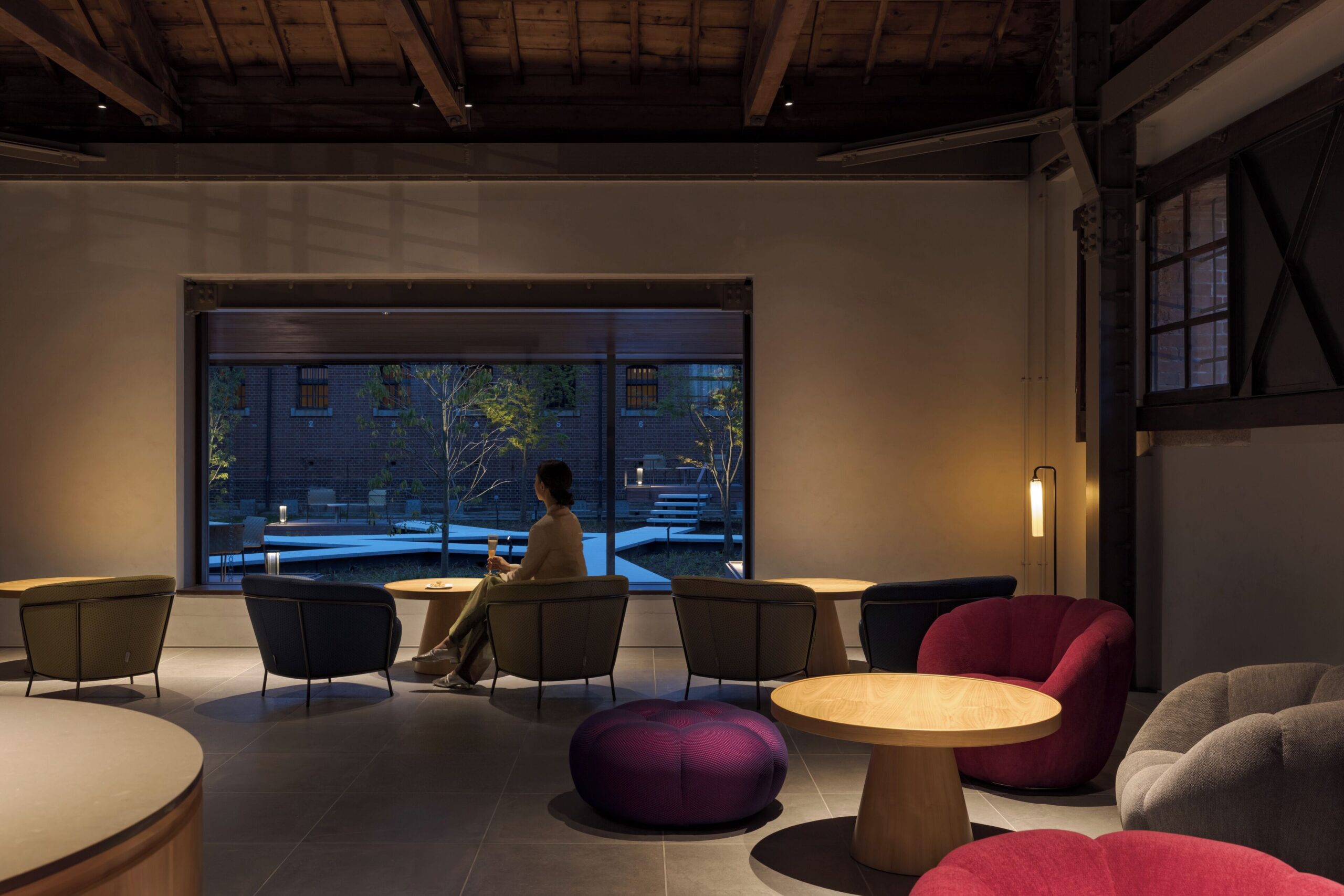 Dining lounge at HOSHINOYA Nara Prison overlooking the courtyard through a large window